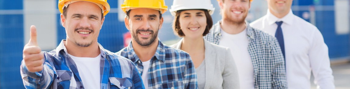 group of smiling builders in hardhats outdoors Personnel services